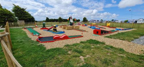 a playground with many play equipment in a yard at 3 Manor Villas Newquay in Newquay