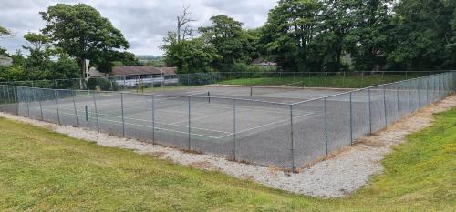a tennis court with two tennis courts at 3 Manor Villas Newquay in Newquay