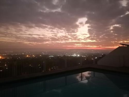 a sunset from the rooftop of a building at Palm View Guest House in Pretoria