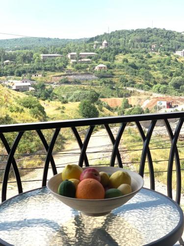 a bowl of fruit sitting on top of a table at Harmony Resort in Tsaghkadzor