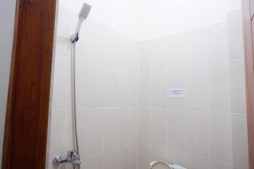 a bathroom with a shower with a toothbrush in it at Reddoorz at Bale Eja Syariah Senggigi in Montongbuwoh