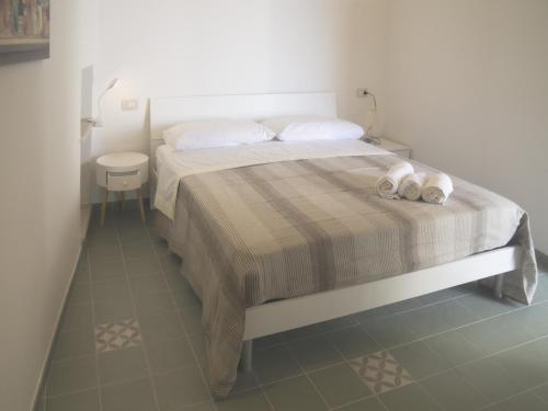 a bedroom with a bed with two towels on it at Terrazza Grecale in Rodi Garganico