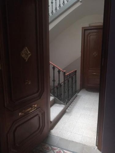 an open door to a hallway with a stair case at Pis Cèntric in Manresa