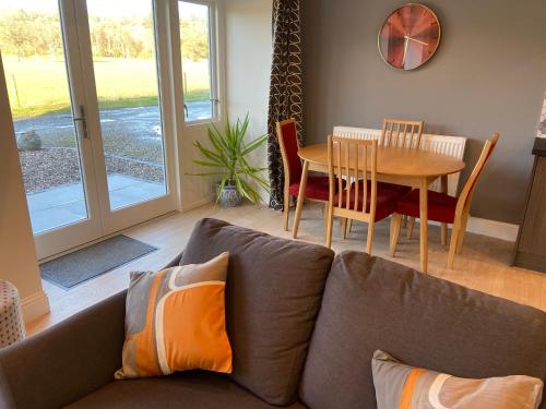 a living room with a couch and a table at The Granary in Stirling