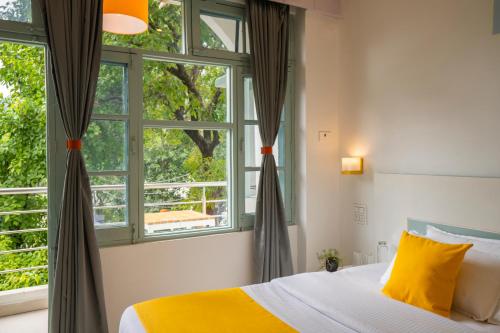 a bedroom with a bed and a window at Zostel Rishikesh, Laxman Jhula in Rishīkesh