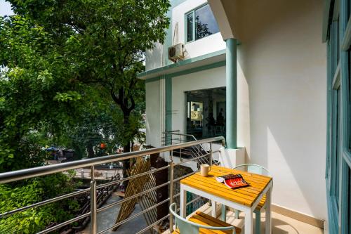 a table on the balcony of a building at Zostel Rishikesh, Laxman Jhula in Rishīkesh