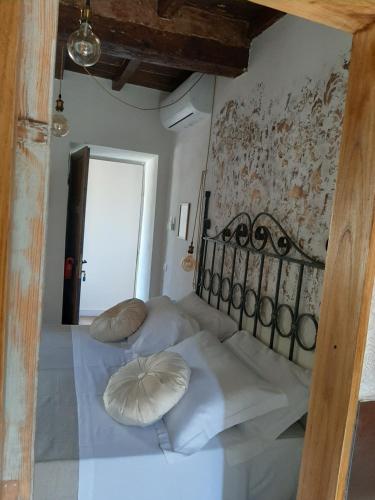 a bedroom with a bed with white sheets and pillows at Toscana Made in Love in Massa