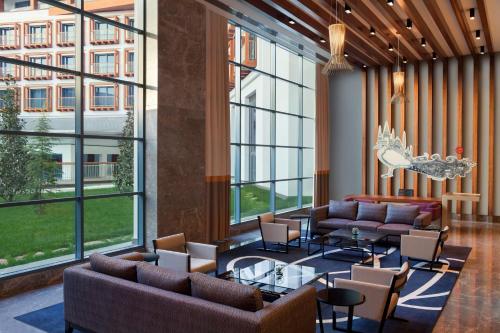 a lobby with couches and tables and large windows at Radisson Blu Hotel & Spa, Istanbul Tuzla in Istanbul