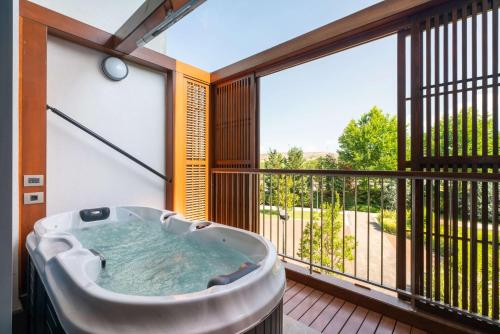 a hot tub on a balcony with a large window at Radisson Blu Hotel & Spa, Istanbul Tuzla in Istanbul