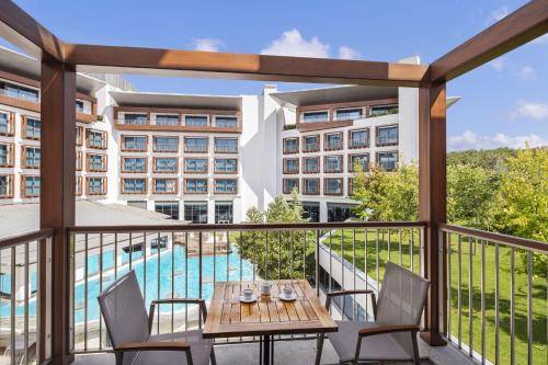 a balcony with a table and chairs and a pool at Radisson Blu Hotel & Spa, Istanbul Tuzla in Istanbul