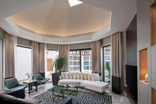 a living room with a white couch and a large window at Radisson Blu Hotel & Spa, Istanbul Tuzla in Istanbul