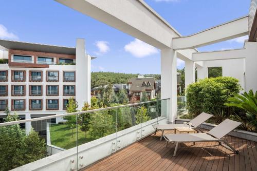 a balcony with two chairs and a building at Radisson Blu Hotel & Spa, Istanbul Tuzla in Istanbul