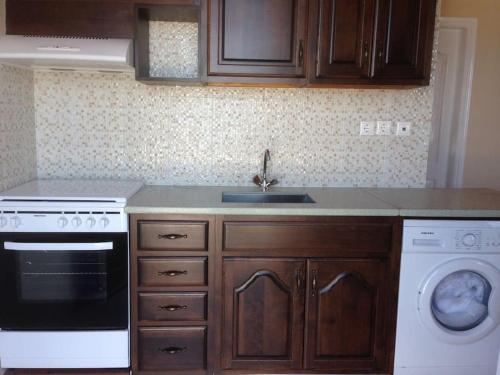 a kitchen with a sink and a dishwasher at Marina Square in Páloi