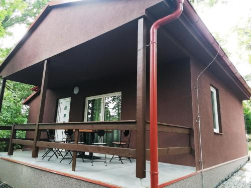 a small house with a red pipe coming out of it at Chaty a Apartmány Hracholusky Kemp Kosatka in Pňovany