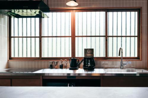a kitchen with a sink and a coffee maker at mysa hakone in Hakone