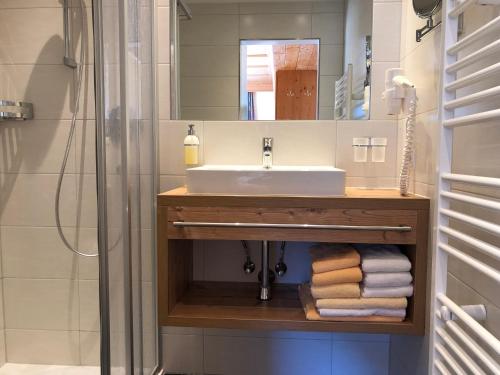 a bathroom with a sink and a mirror at Saffretta Ferienwohnungen in Ischgl