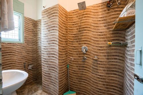 a bathroom with a shower and a sink at Zostel Rishikesh, Laxman Jhula in Rishīkesh