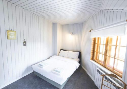 ミルフカにあるDom w Milówceのベッドと窓が備わる小さな客室です。