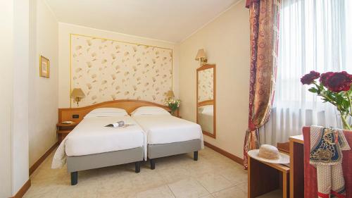 Ένα ή περισσότερα κρεβάτια σε δωμάτιο στο Bes Hotel Villa Zoia