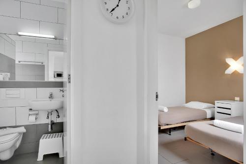 a small bathroom with a sink and a bed at Apartamentos LIVVO Mar Azul - Adults Only in Corralejo