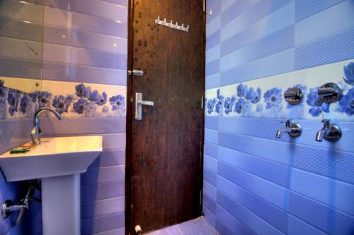 a bathroom with a sink and a shower at Ark of Avalon DEL - FREE Airport Drop in New Delhi