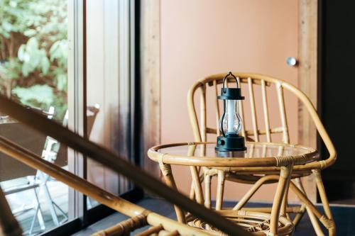 a lantern sitting on a chair next to a window at mysa hakone in Hakone