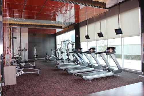 a row of tread machines in a gym at Novotel Bangka Hotel & Convention Center in Pangkalpinang