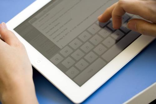 a person typing on a tablet computer at Amaris Hotel Teuku Umar in Denpasar