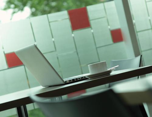 a laptop computer sitting on a table next to a window at Amaris Hotel Teuku Umar in Denpasar