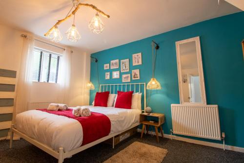 a bedroom with a bed with a stuffed animal on it at Cozy, Chic, Dairy Cottage near to Beach & Shops- Parking in Torquay