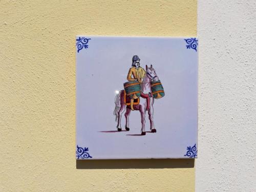 a painting of a man riding a horse on a wall at Case Vacanze Borgo Faraldi in Villa Faraldi