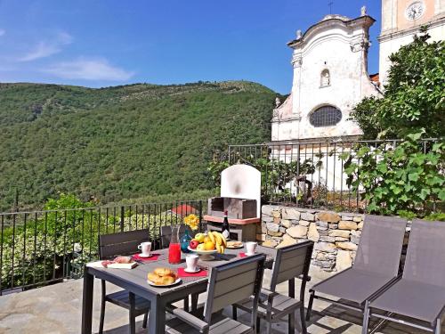 a table and chairs on a patio in front of a building at Case Vacanze Borgo Faraldi in Villa Faraldi