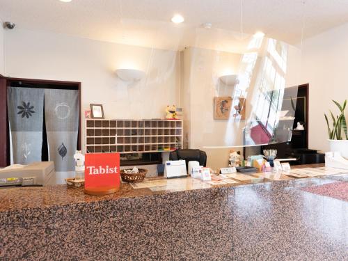 a kitchen with a counter with a counter top at Tabist Travel Inn Shinshu Nakano in Nakano