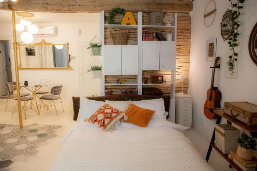 a bedroom with a bed and a guitar in a room at Rosalia Apartment in Koper