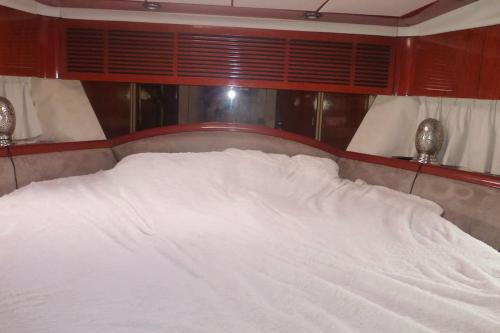 a bed with white sheets on it in a room at SAS L étoile de mer in Argelès-sur-Mer