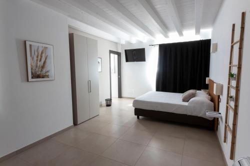 a bedroom with a bed and a large window at Agriturismo Tiare dal Gorc in Gorgo