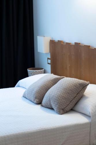 a bed with two pillows on top of it at Agriturismo Tiare dal Gorc in Gorgo