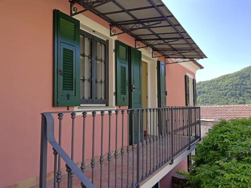 a balcony of a house with green shutters at Case Vacanze Borgo Faraldi in Villa Faraldi