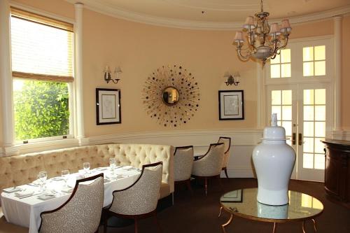a dining room with a table and chairs and a chandelier at Hotel Majestic in San Francisco