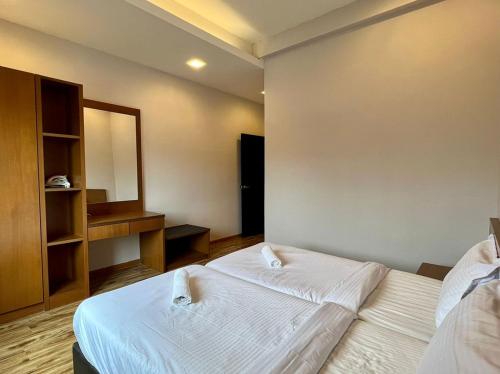 a bedroom with two beds and a mirror at PLAY at Nova Retreat Kea Farm in Cameron Highlands