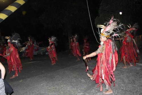a group of children in red costumes performing a dance at Highland Resort & Nature Tours in Tomohon
