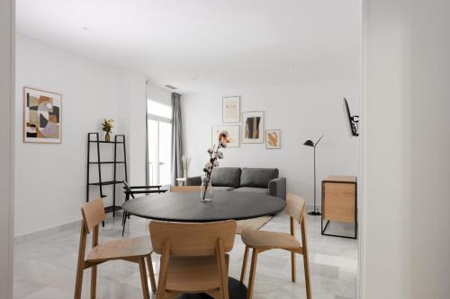 een woonkamer met een tafel en stoelen bij Sonder Santa Ana in Madrid