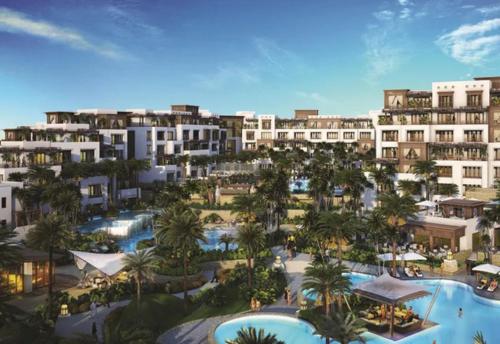 una vista aérea de un complejo con palmeras y piscinas en Nasma Luxury Stays - Fancy Apartment With Balcony Close To MJL's Souk en Dubái