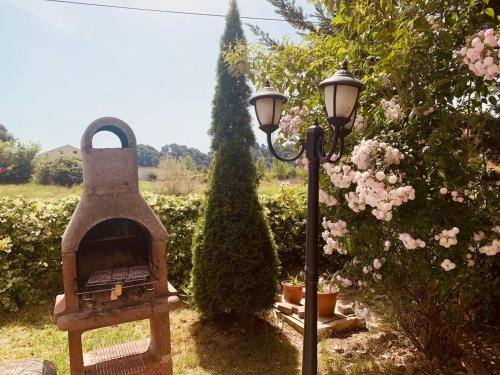a outdoor oven next to a street light at Family Tree - WATER Available - SELF check in in Golem