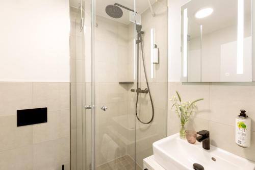 a bathroom with a shower and a sink at Koopmanns Hotel und Lädchen in Göhren