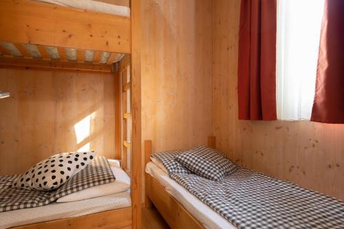 a bedroom with two bunk beds and a window at Camping Brione in Riva del Garda