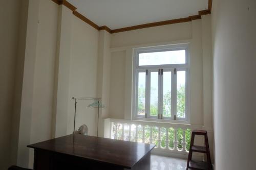 a window in a room with a desk and a chair at Moon house tropical garden - West side in Nha Trang