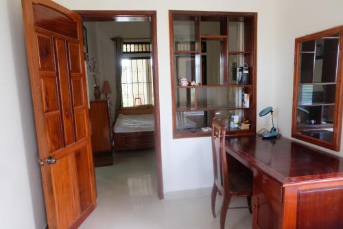 an office with a wooden desk and a room at Moon house tropical garden - West side in Nha Trang