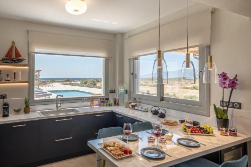 a kitchen with a table with food and wine glasses at Villa Armelina in Plaka