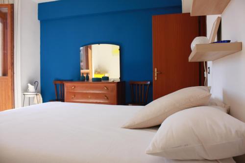 a bedroom with blue walls and a bed with pillows at Fiore di Piesco-b&b di charme in Satriano di Lucania